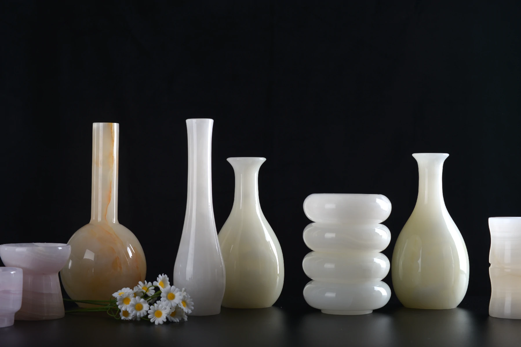 Sculptural onyx vases with one-of-a-kind veining and translucent colour.