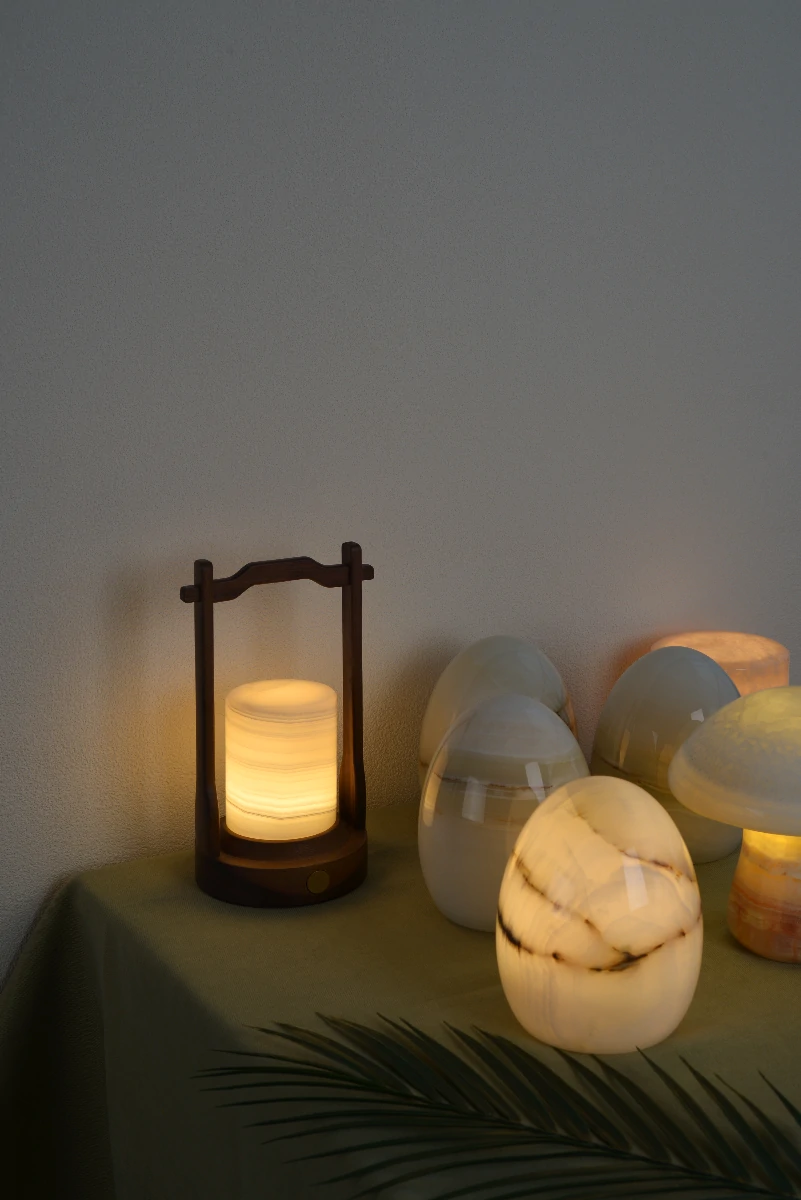Natural onyx table lamps glowing softly and showing their unique patterns.