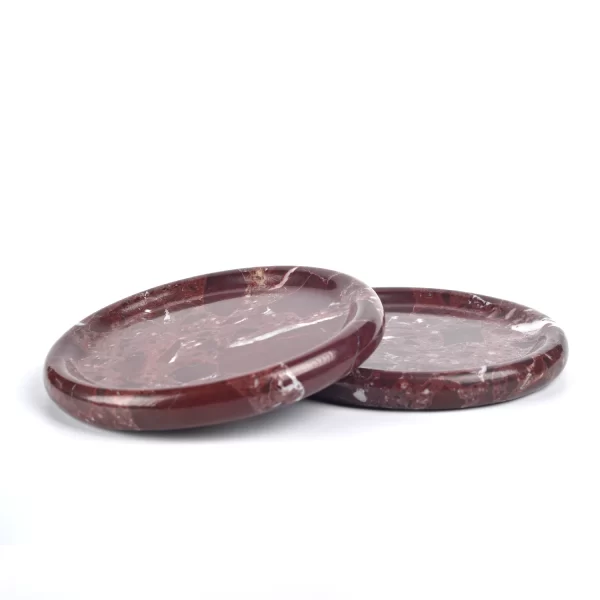 Two round burgundy marble trays with stunning natural red patches and white veining, polished to a smooth finish.