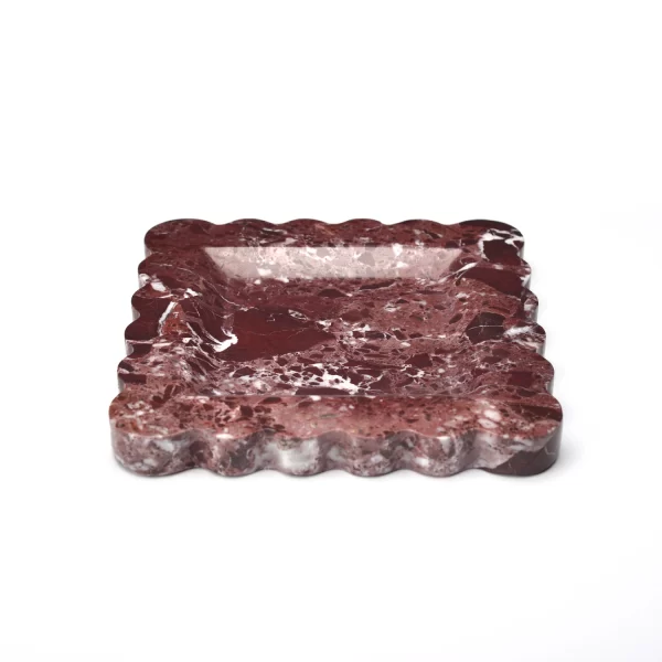 Side view of the scalloped edge square burgundy marble tray, highlighting the fan-shaped edge contours, with a smooth, reflective surface and natural red and white veining.