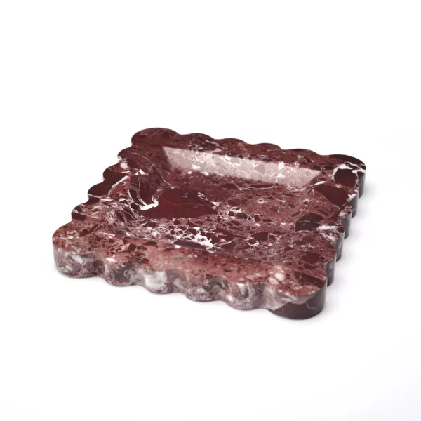 Side view of the square burgundy marble tray with scalloped edges, showcasing the elegant fan-shaped edge design and smooth, reflective surface.