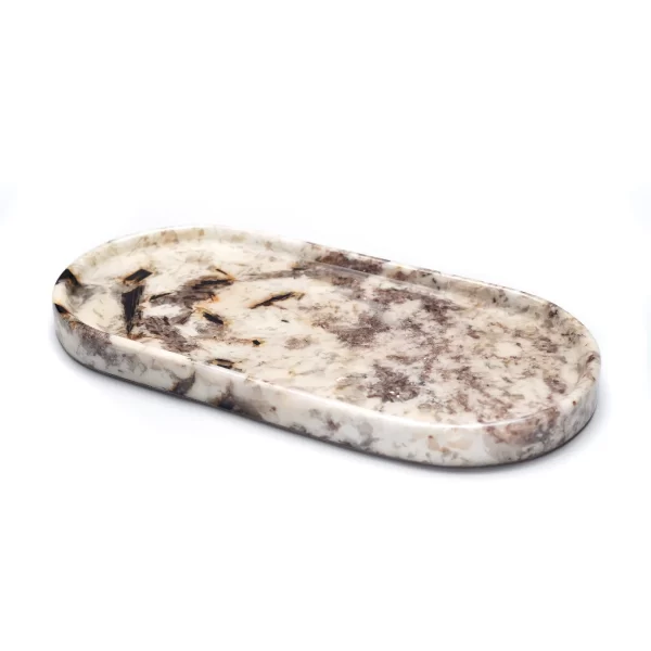 Close-up of the Oval Patagonia Blanc Stone Tray, emphasizing its intricate brown and beige veining, crystal formations, and glossy glaze finish.