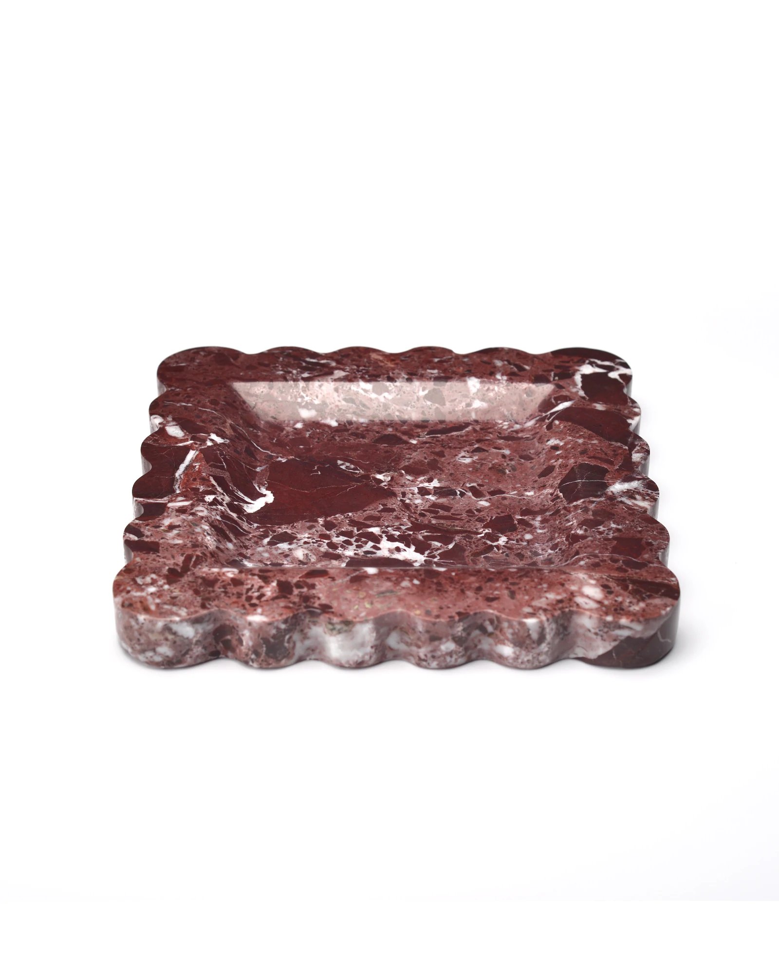 Side view of the scalloped edge square burgundy marble tray, highlighting the fan-shaped edge contours, with a smooth, reflective surface and natural red and white veining.