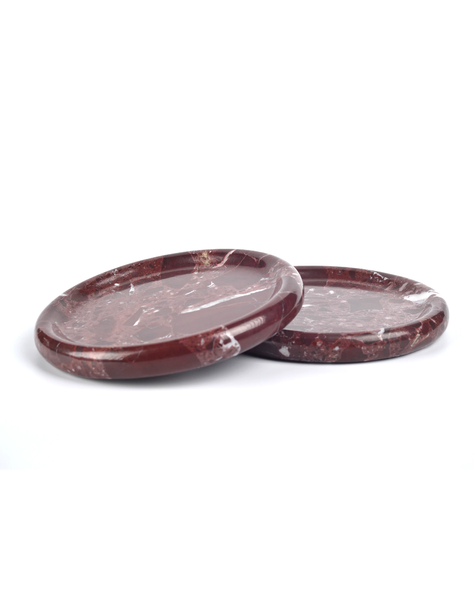 Several Round Burgundy Marble decorative trays with polished red marble and white veining