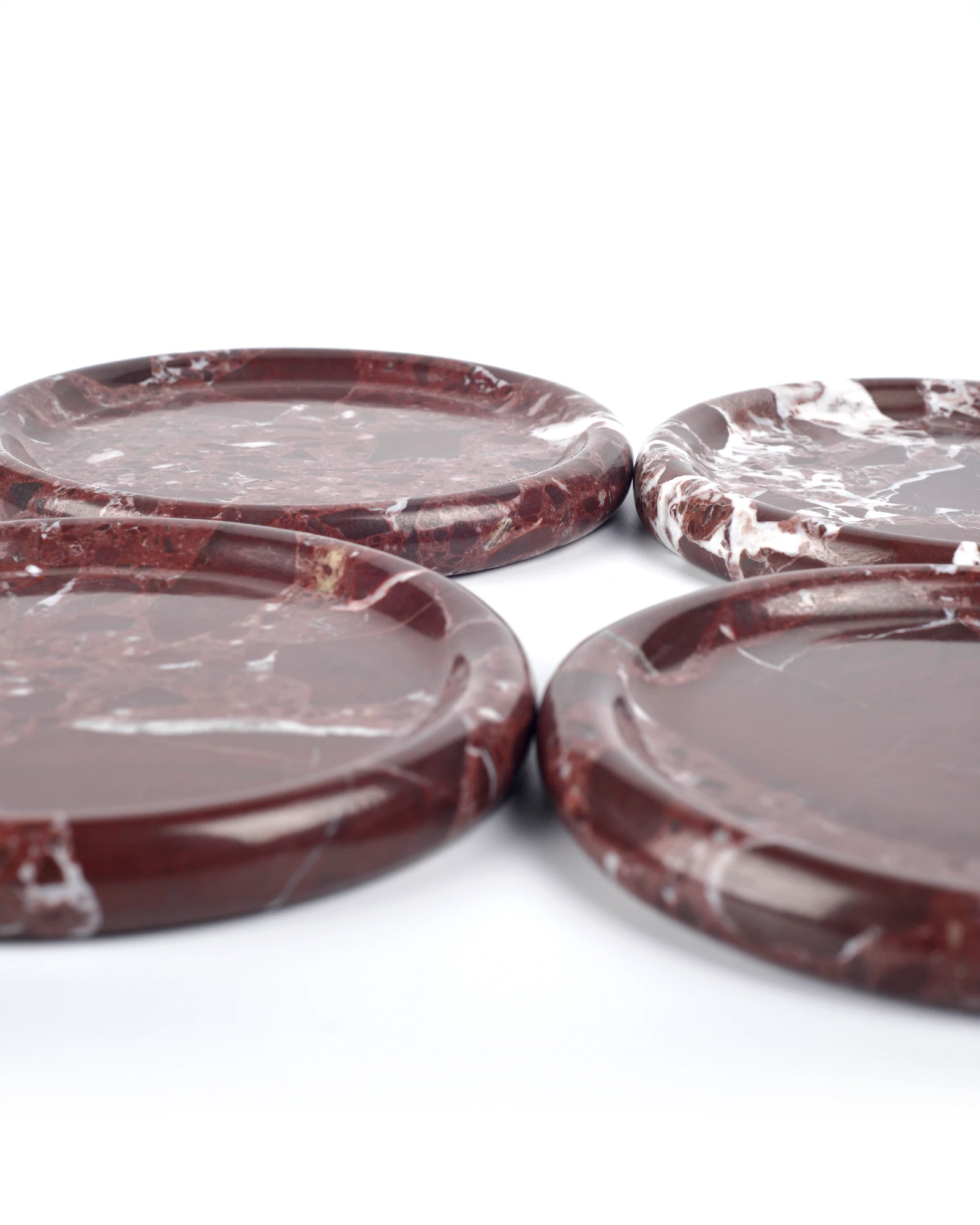 Polished Round Burgundy Marble trays with natural red color blocks and white veining, arranged as decorative trays