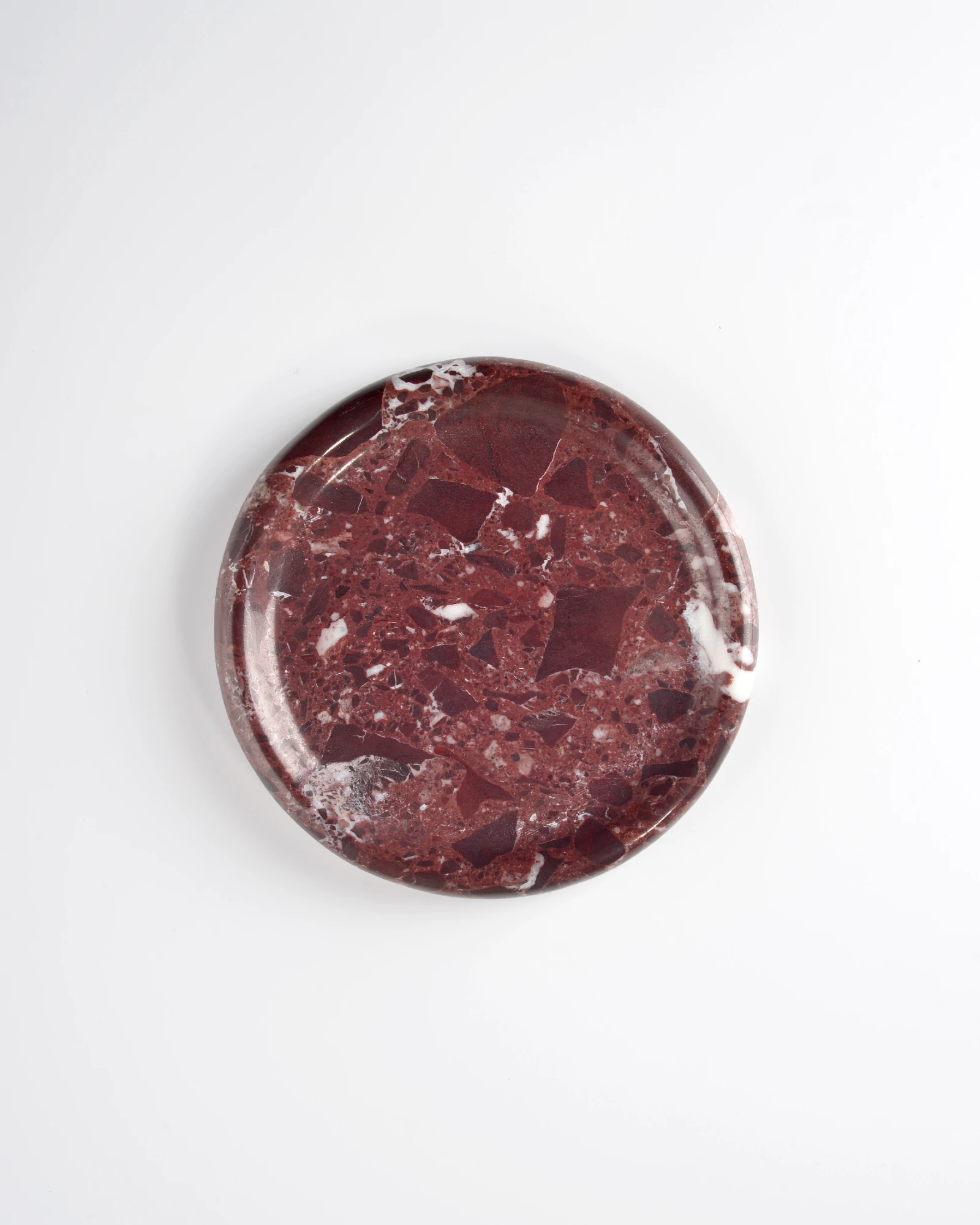 Overhead detail of Round Burgundy Marble Tray with polished surface and rich red color blocks