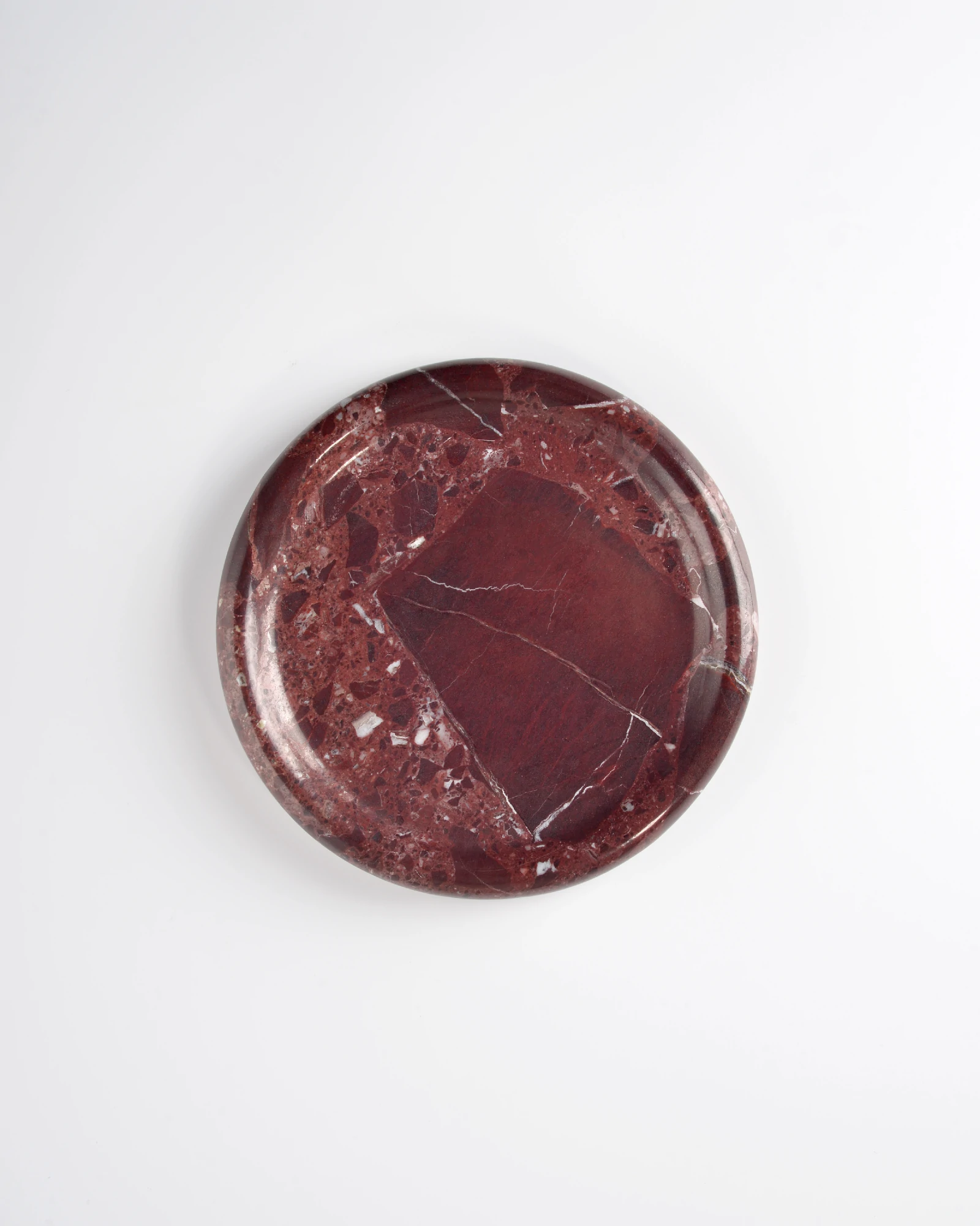 Detailed top view of Round Burgundy Marble Tray with polished surface and natural red veining