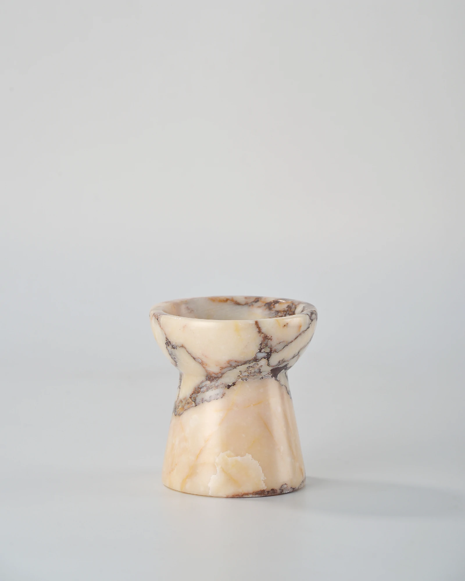 Calacatta Marble candle holder shaped like a small torch, with translucent marble and intricate veining