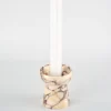 Rectangular aromatherapy candle placed on the small torch-shaped Calacatta Marble candle holder, showcasing its handcrafted design