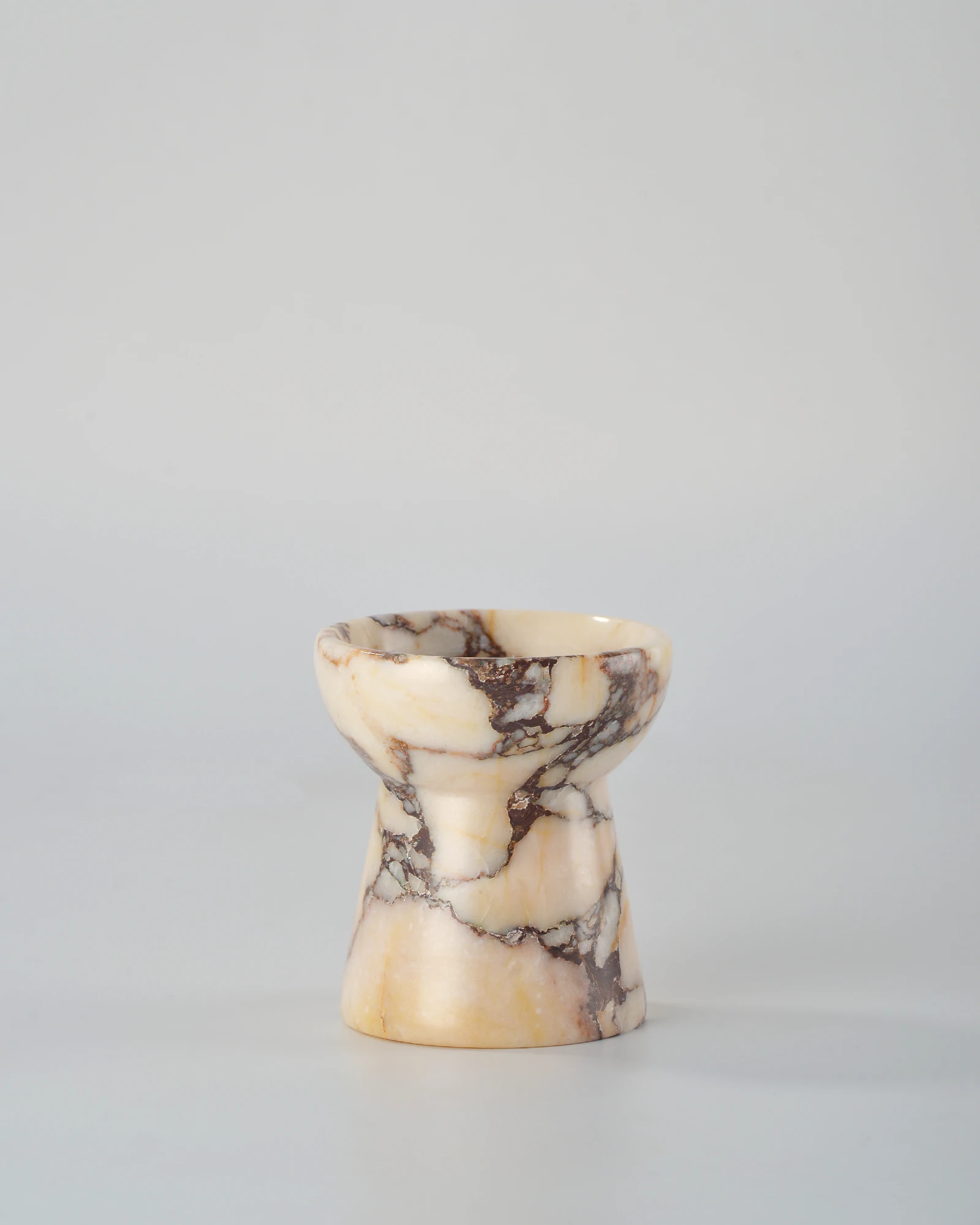 Small torch-shaped Calacatta Marble candle holder, a finely crafted and stylish home decor piece