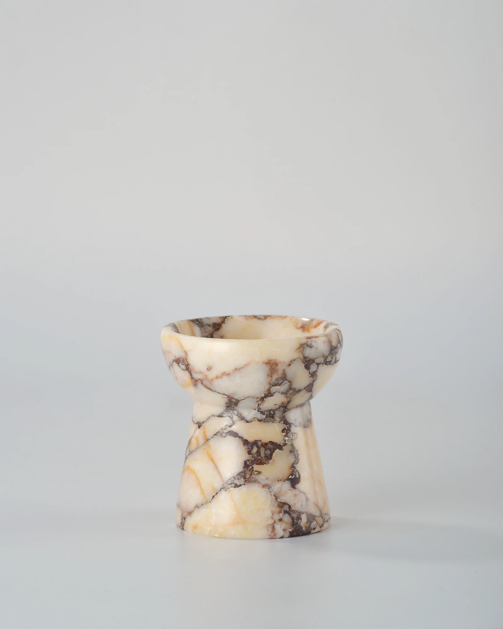 Handcrafted Calacatta Marble candle holder shaped like a small torch, an elegant and compact home decor item