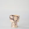 Handcrafted Calacatta Marble candle holder with brown-red veining and beige base, shaped in a classic geometric form
