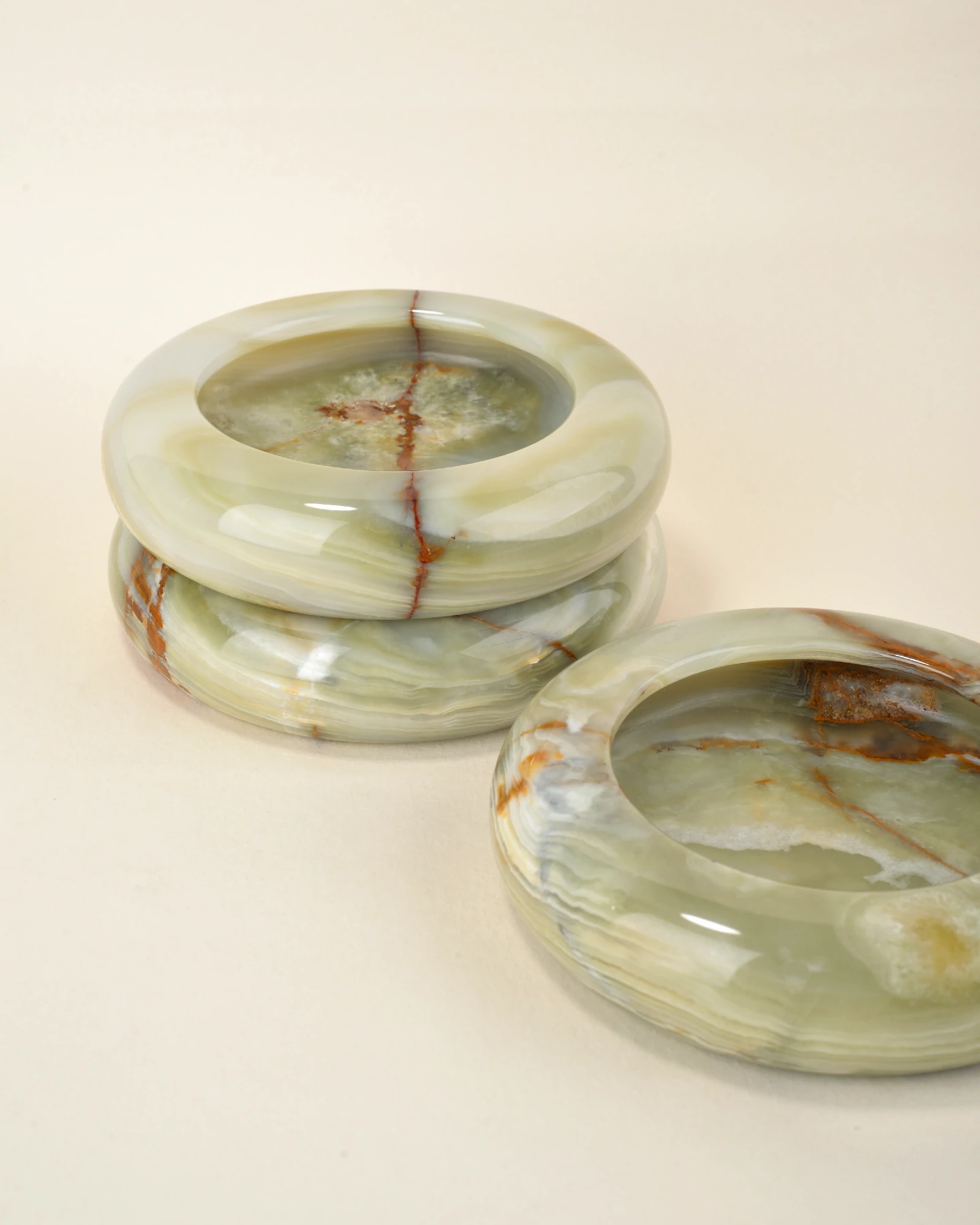 Several polished Round Green Onyx Ashtrays for cigars and cigarettes, showing unique natural veining
