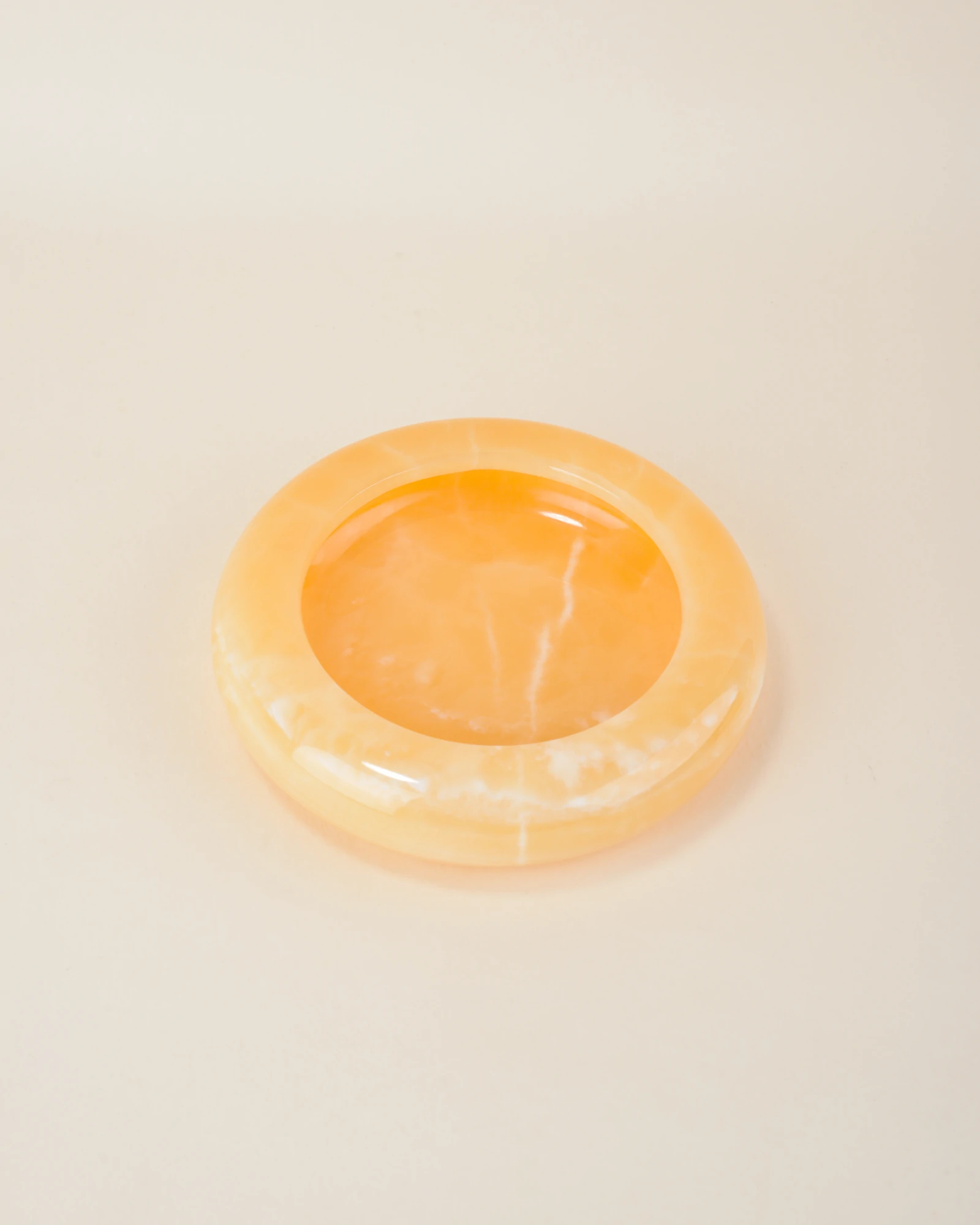 Polished Round Orange Onyx Ashtray with natural white veining, ideal for cigar and cigarette smokers