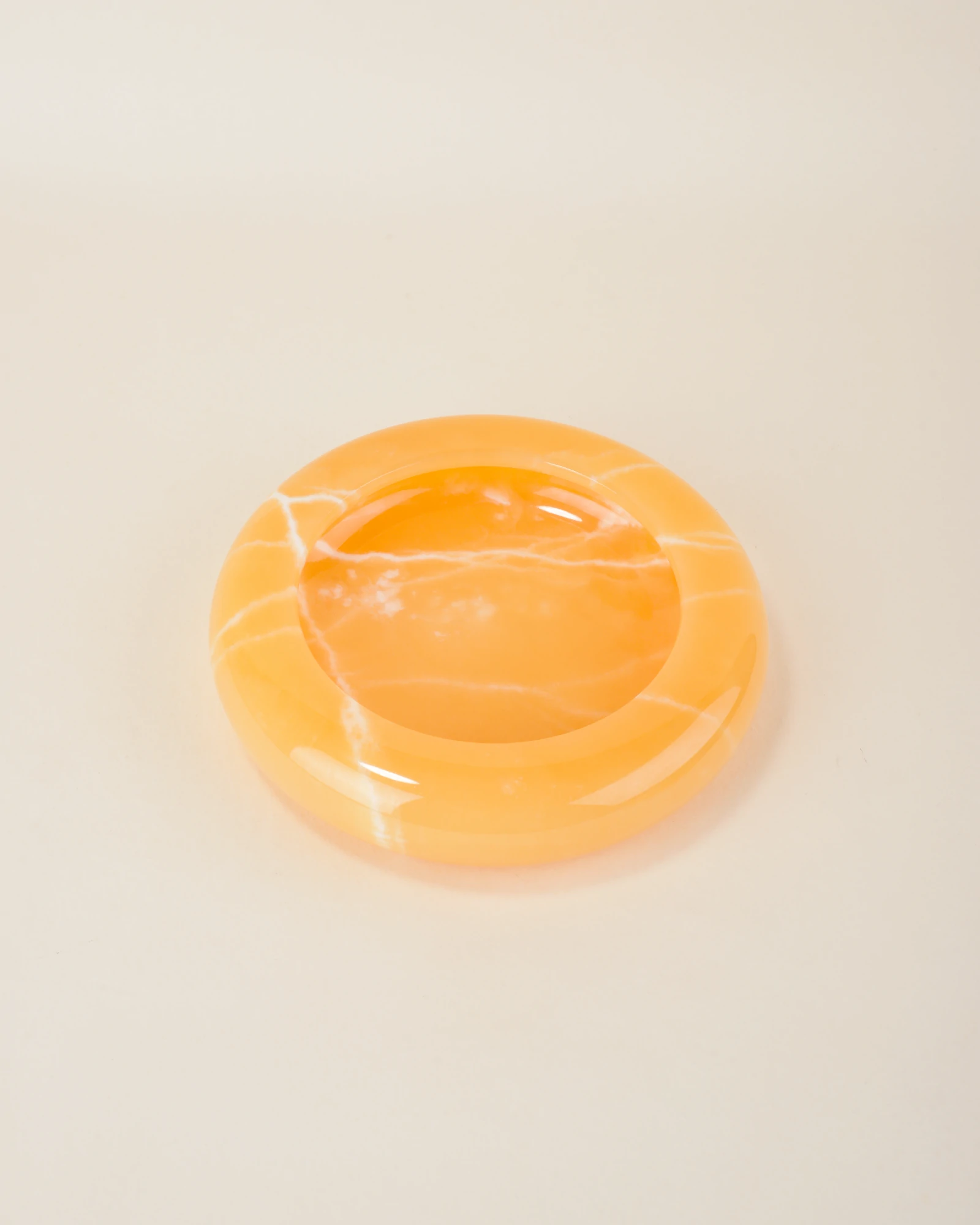 Smooth Round Orange Onyx Ashtray with white natural veins, perfect for cigars and cigarettes
