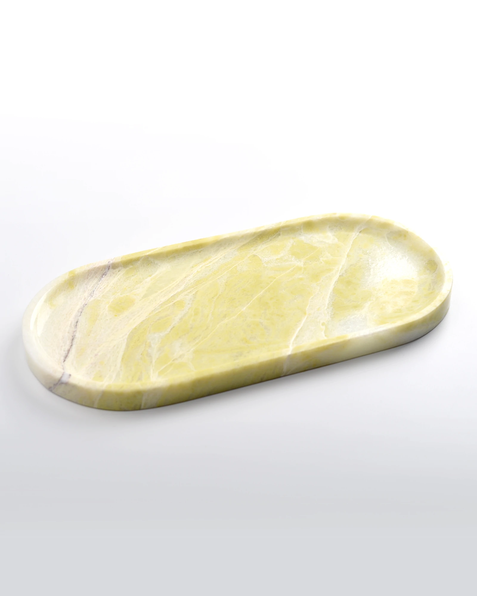Polished natural surface of Oval Yellow Marble Tray, placed on a white background