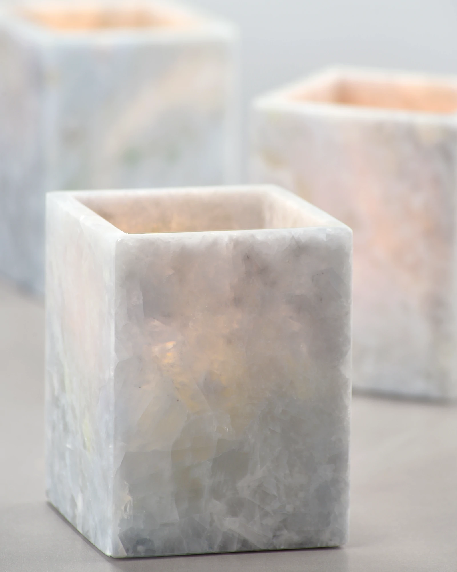 Close-up of glowing Blueish Crystal Marble Candle Holder, showing ice-like veining and light-diffusing marble texture