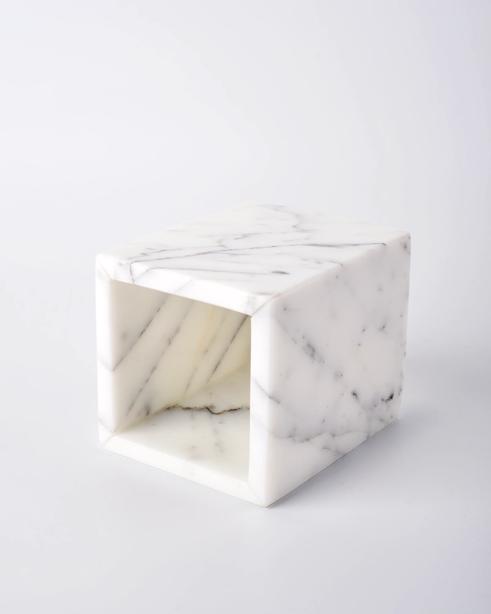 Marble candle holder laid on its side showing inner cup depth