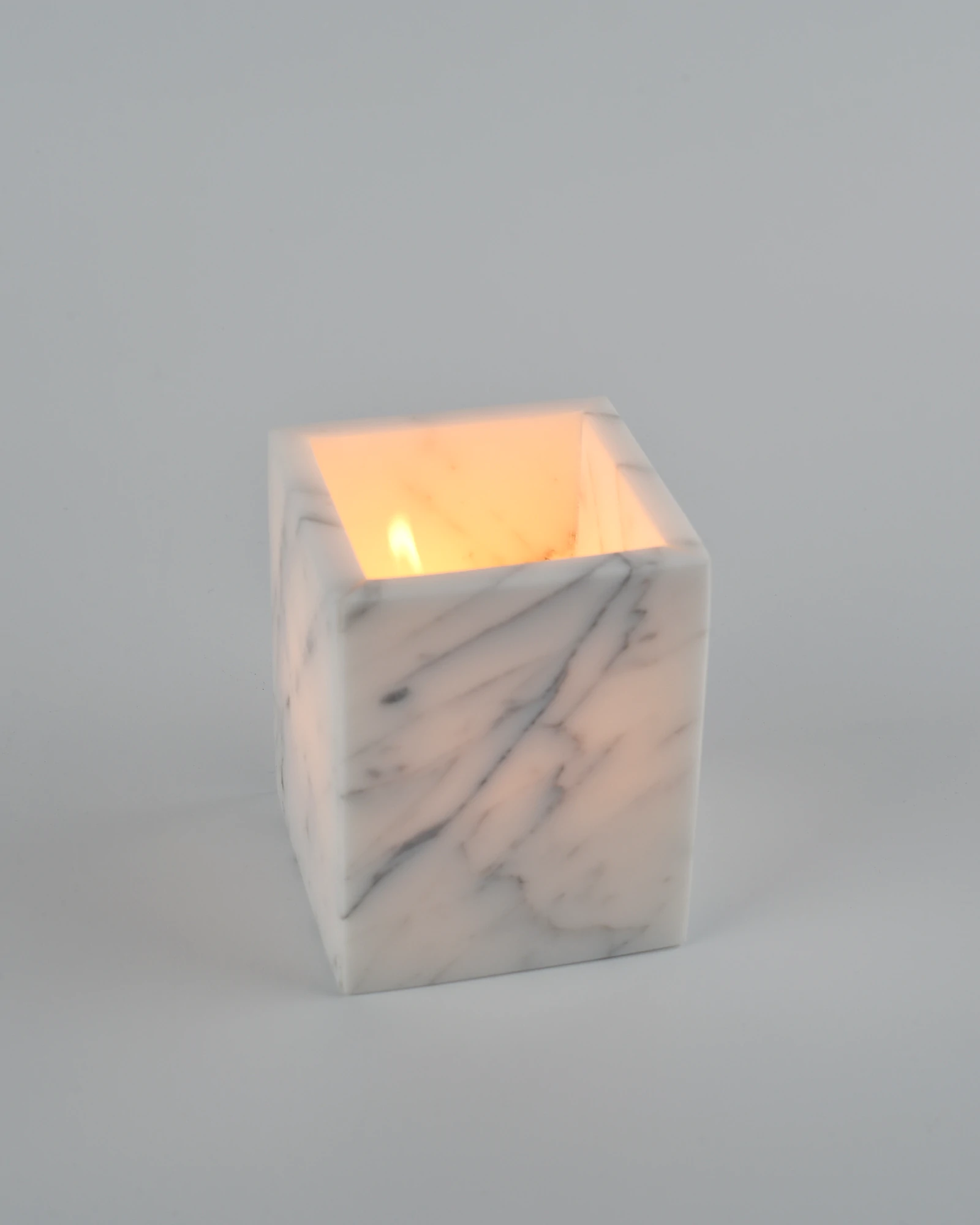 Candle flame reflected on polished marble interior