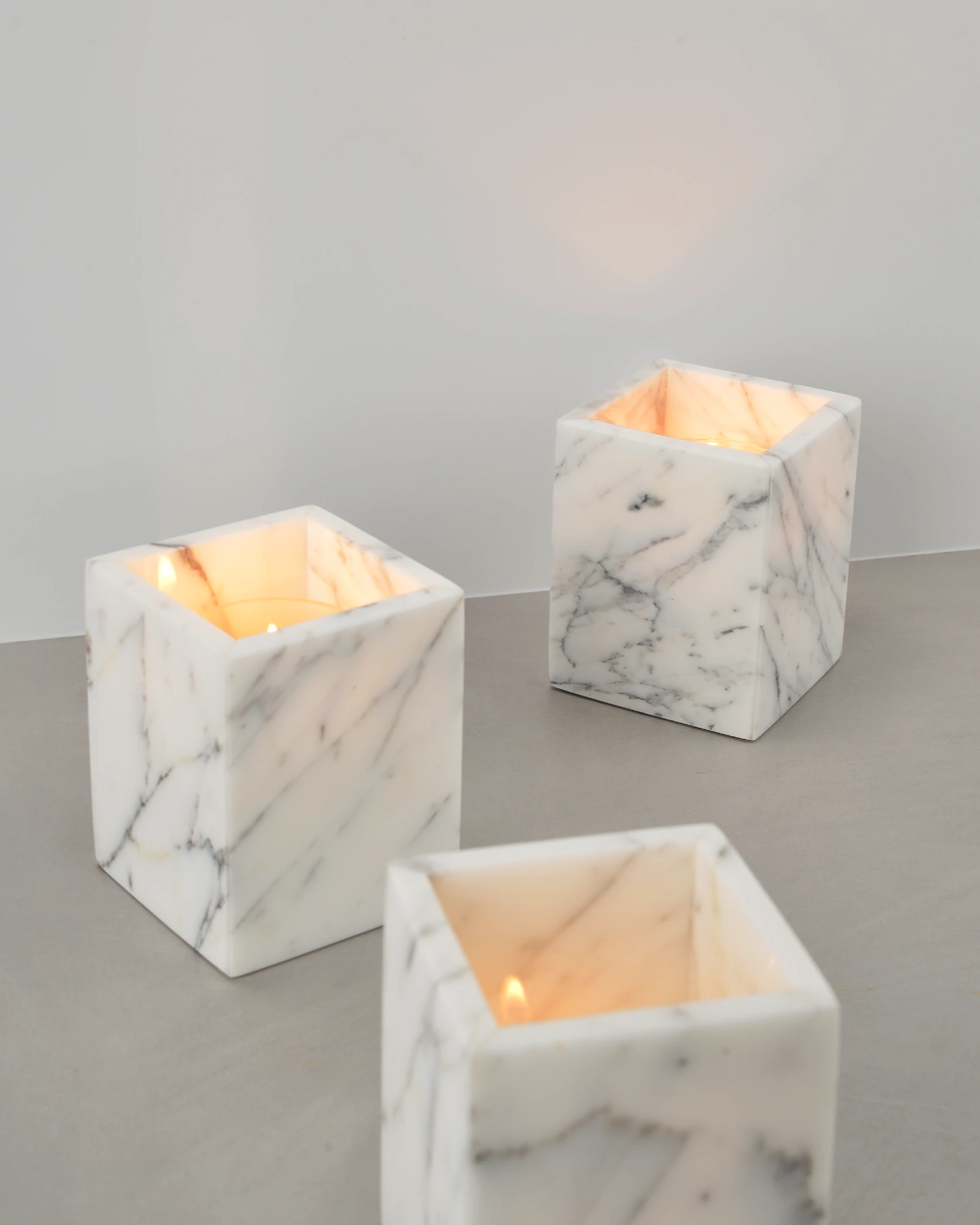 Unique natural marble candle holders displayed on a table