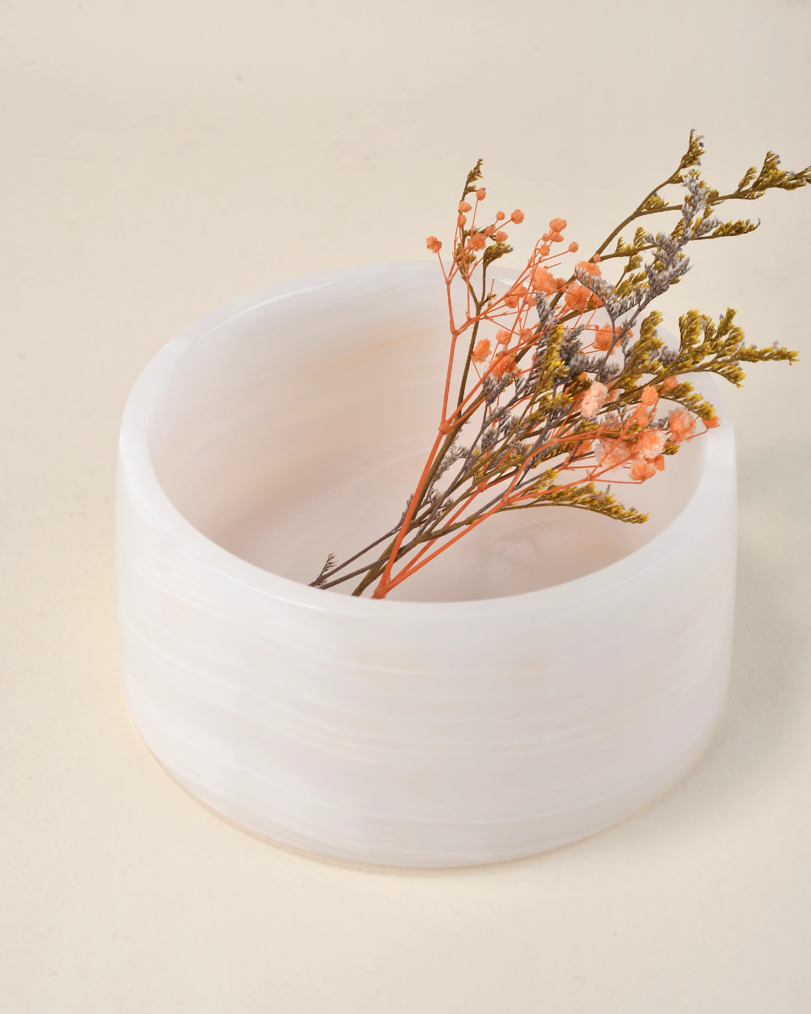 Round Pink Onyx decorative bowl with light pink, white, and yellow natural veining, 14.5cm wide