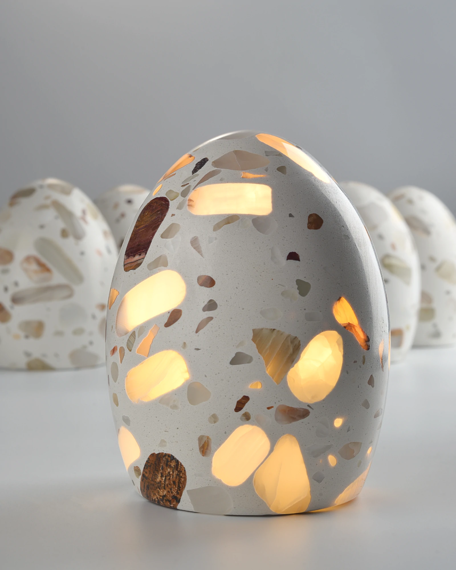 Handmade onyx lamps with slight shape variations shown on tabletop