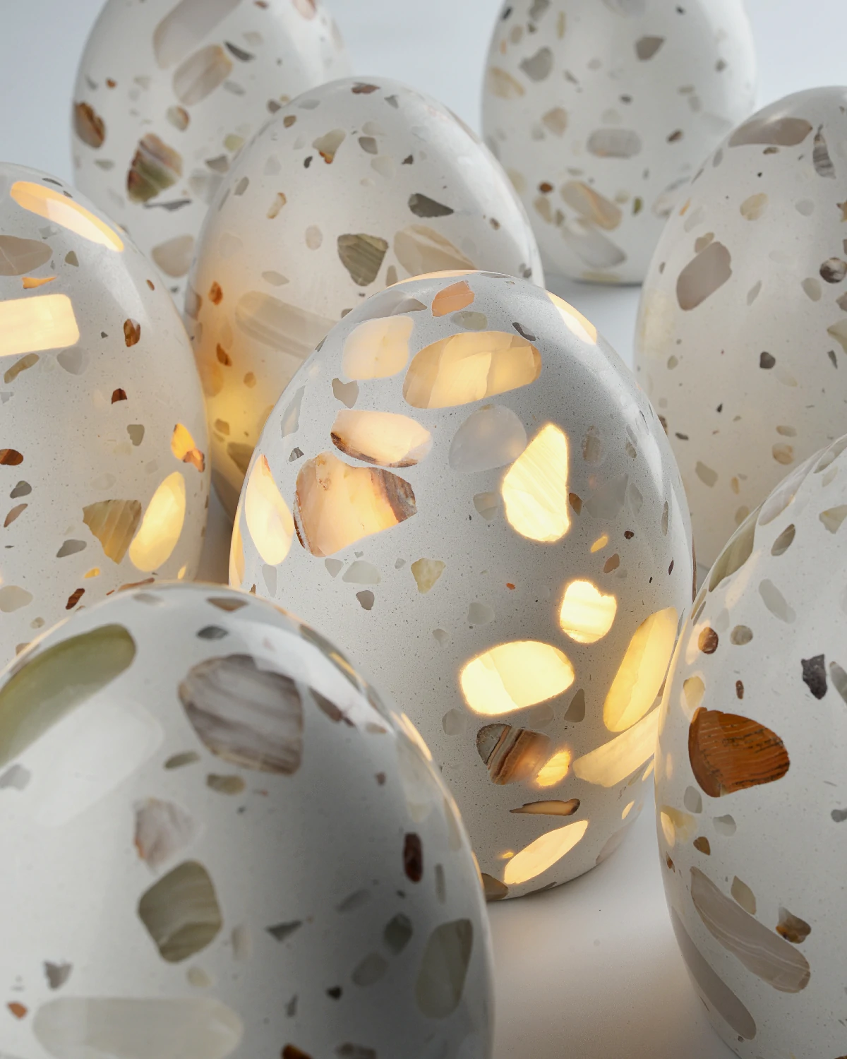 Multiple egg-shaped onyx lamps with unique colors and veining