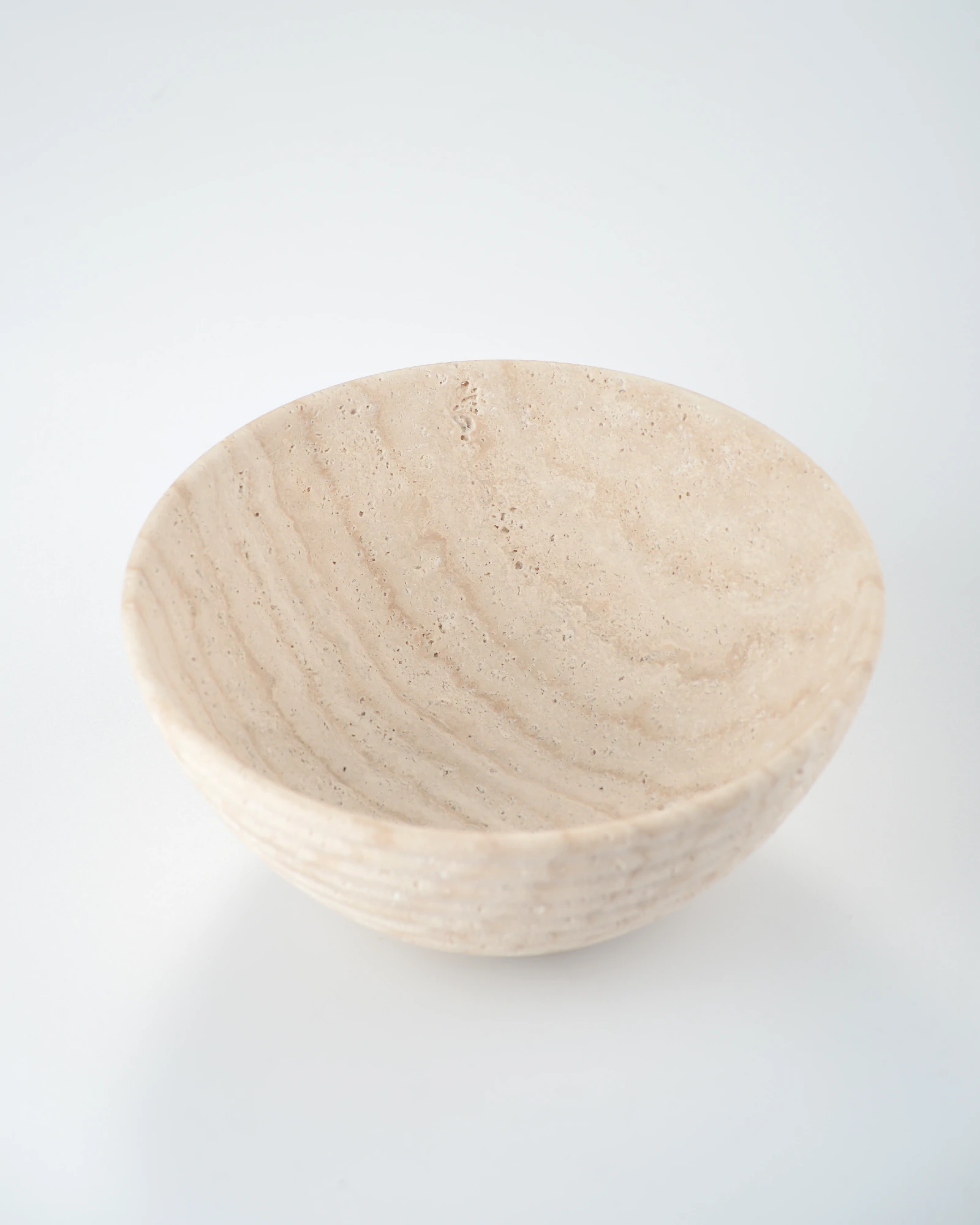 Top view of travertine round bowl showing striped natural stone patterns