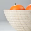 Close-up of travertine bowl’s grooved outer surface with natural pores