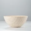 Side view of travertine bowl with grooved exterior and light-shadow details