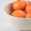 Travertine round bowl with oranges used as a catchall tray or serving bowl