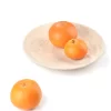 Travertine plate with assorted fruits creating elegant tabletop decor