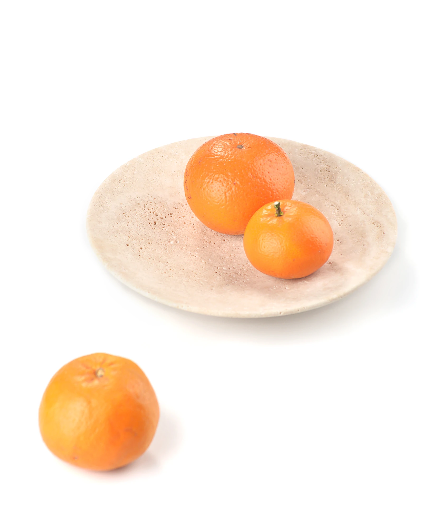 Travertine plate with assorted fruits creating elegant tabletop decor