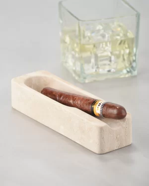 Travertine cigar ashtray with cigar and whiskey glass in background