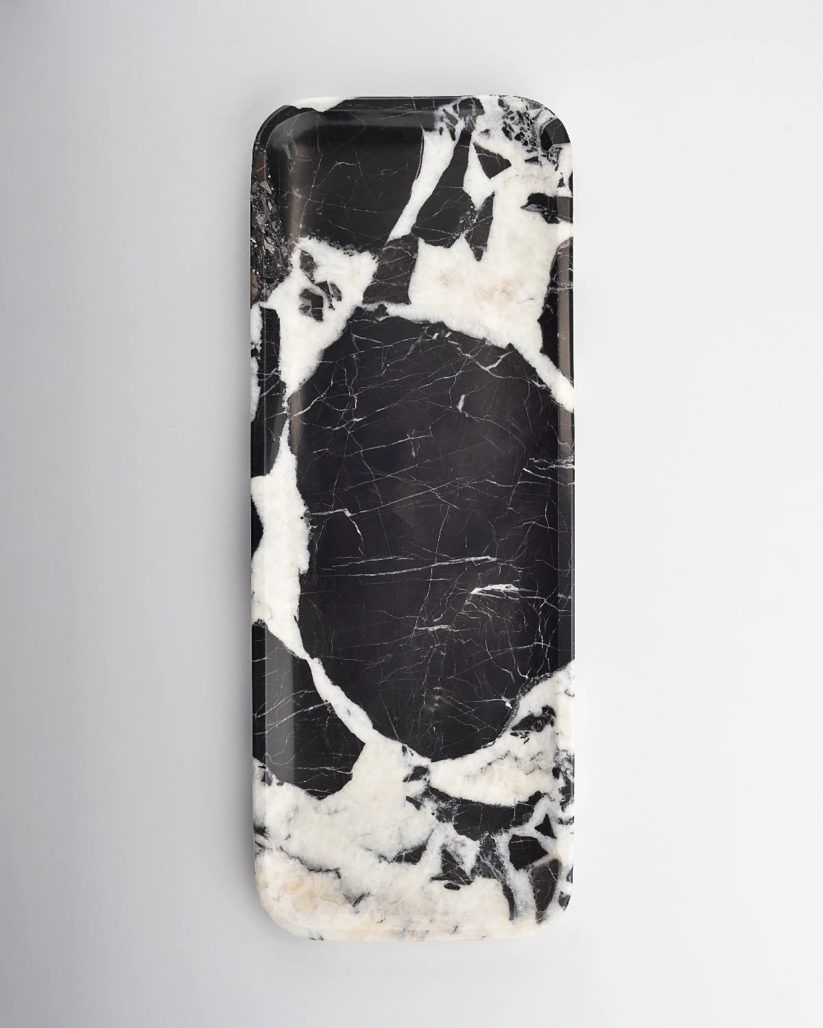 Black marble tray with high contrast veining resembling ink painting