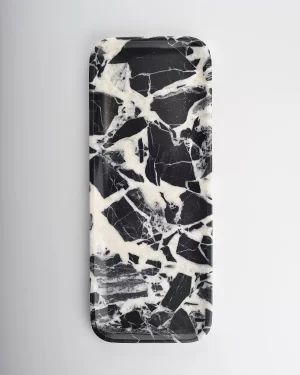 Balanced black and white marble tray resembling a dessert swirl