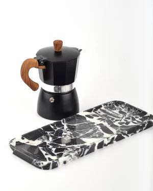 Bvlgari Black Marble Tray next to a coffee pot with reflective polished surface