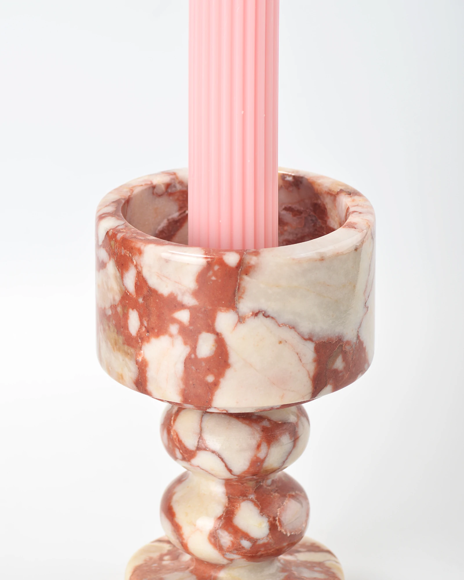 Close-up of marble candle holder rim showing smooth and textured contrast