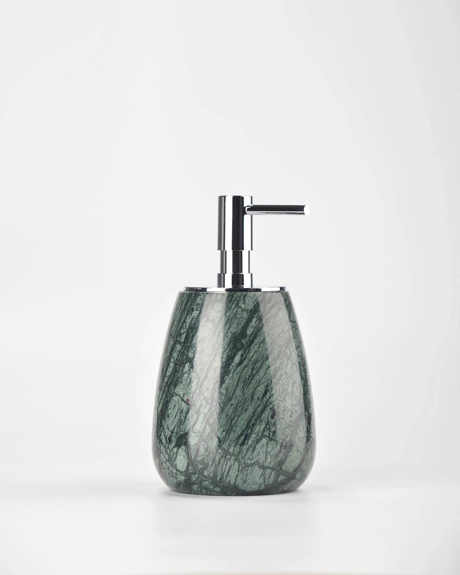 Close-up of small green marble soap dispenser showing leaf-like veining