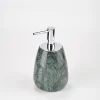 Angled view of small green marble soap dispenser highlighting shape and polish