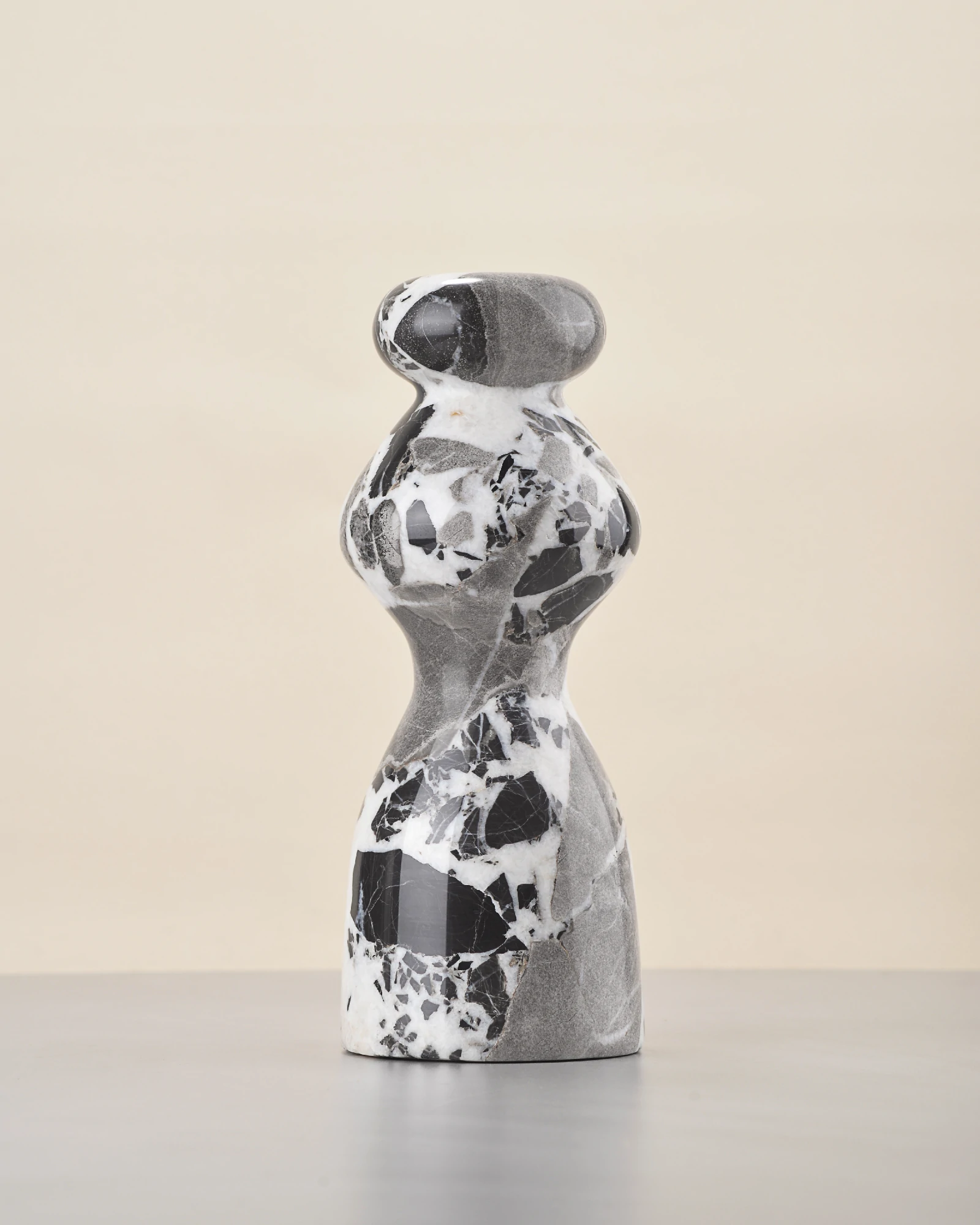 Rear of marble vase with even blend of black, white, and grey tones