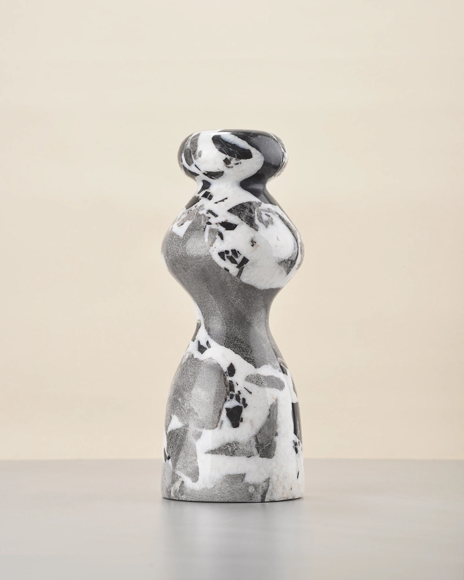 Front of marble vase with grey-dominant tone and scattered black and white inclusions