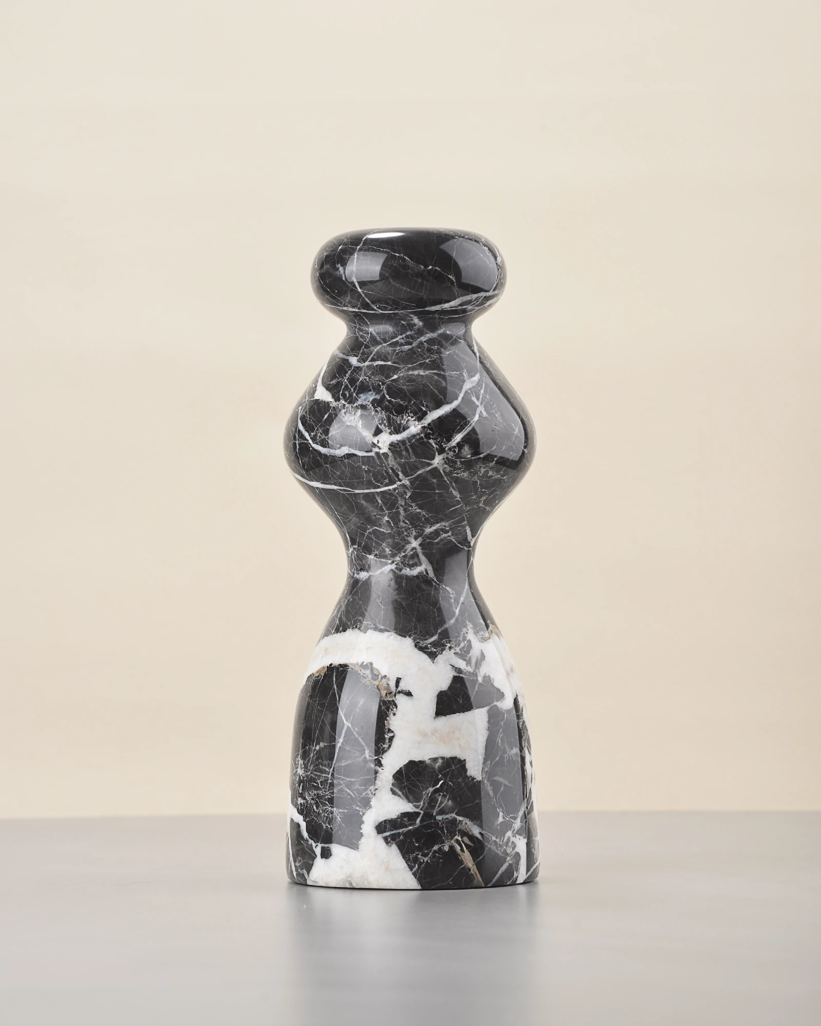 White veining forming a path on black marble vase