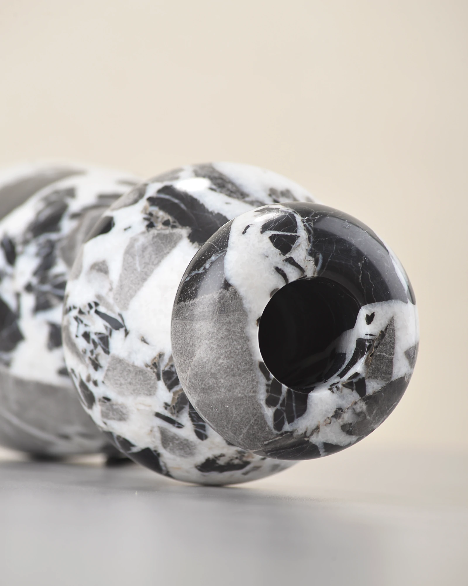 Side view of marble vase showing curved sculptural form