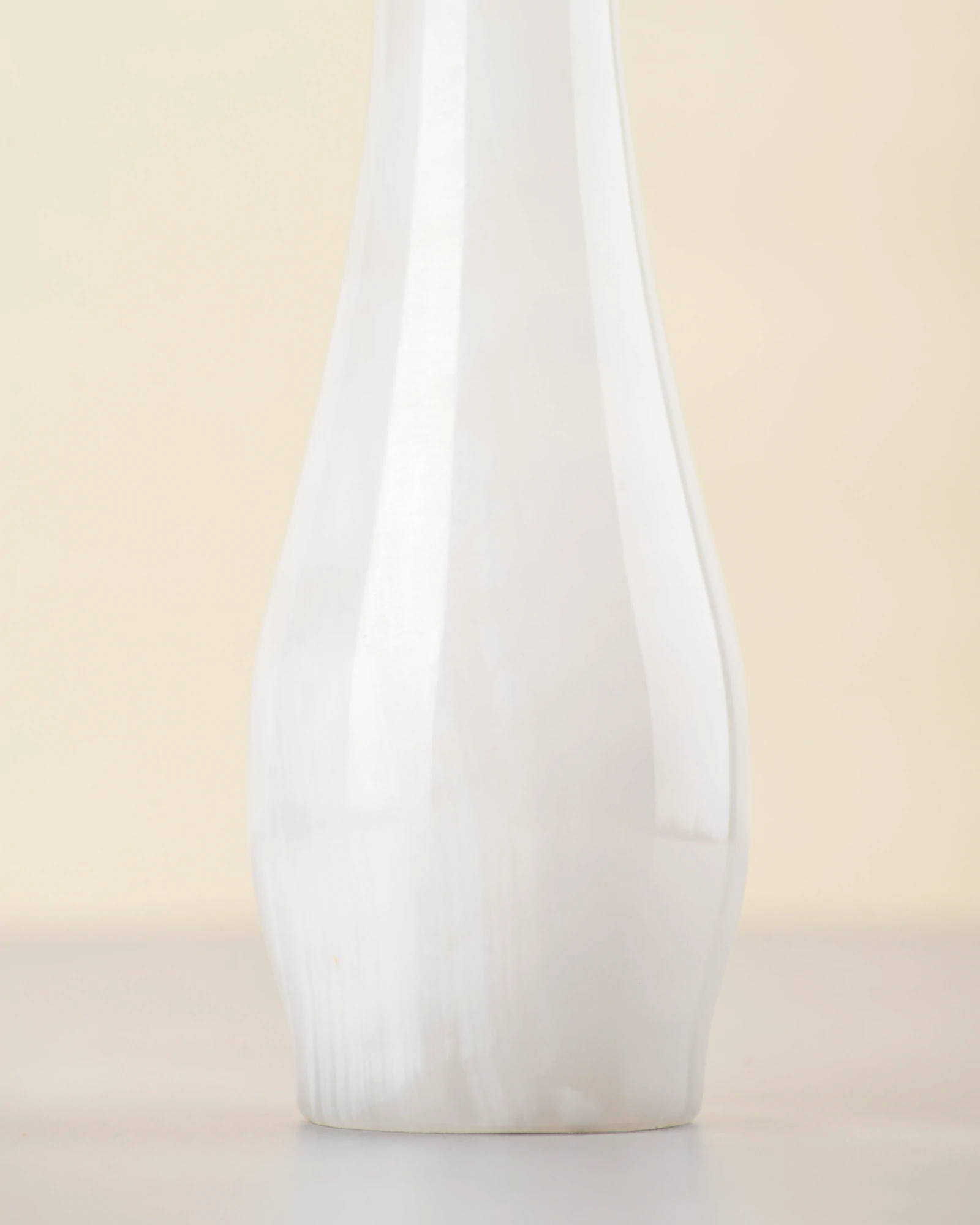 Close-up of white onyx vase body showing cloudy natural patterns