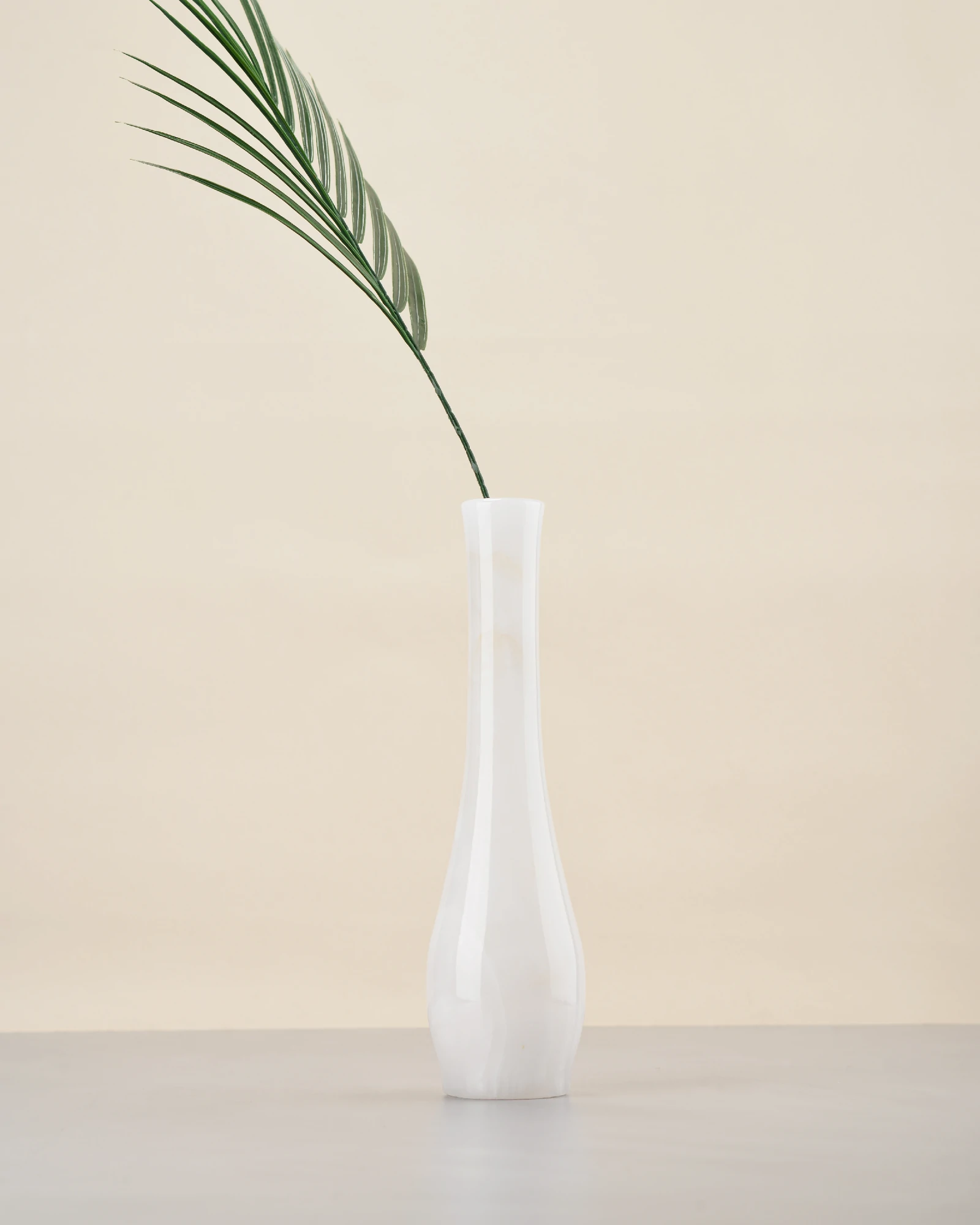 Modern white onyx marble vase with smooth, streamlined silhouette