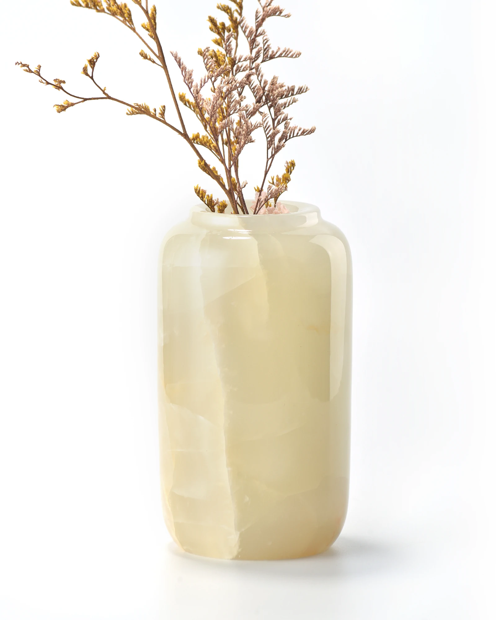 Front view of green onyx vase showing natural crackle texture with dried branches