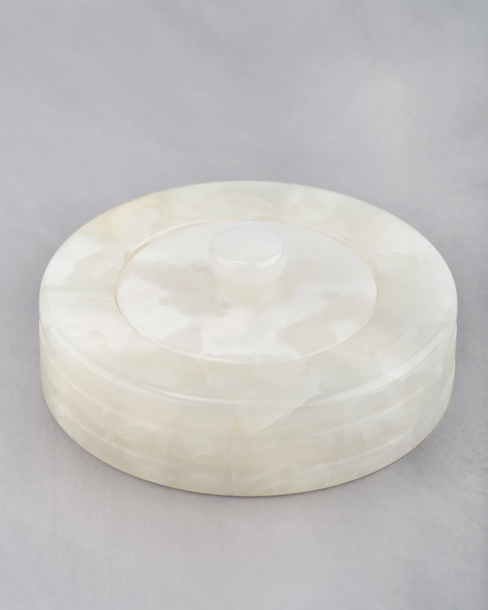 45-degree view of white onyx canister jar with rounded shape