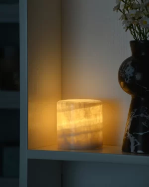 Mini Yellow Onyx Lamp glowing in dark room corner