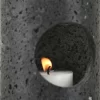 Black Travertine Candle Holder close-up of circular window with candlelight